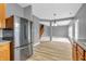 The living room boasts wood floors, gray walls, an open floor plan, and plenty of natural light at 10187 Yosemite Ln, Indianapolis, IN 46234