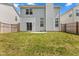 Backyard with a grass lawn, wooden fence, and sliding glass doors to the home at 10427 Apple Creek Dr, Indianapolis, IN 46235