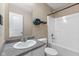 Bathroom featuring a white sink, toilet, and tub with shower at 10427 Apple Creek Dr, Indianapolis, IN 46235