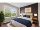 Well-lit bedroom with modern decor, window views, and hardwood floors at 10427 Apple Creek Dr, Indianapolis, IN 46235
