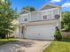 Charming two-story home with a two car garage and landscaped front yard in a residential community at 10427 Apple Creek Dr, Indianapolis, IN 46235