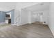Bright living room featuring modern flooring and an open floorplan leading to kitchen and entry at 10427 Apple Creek Dr, Indianapolis, IN 46235