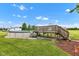Backyard with above ground pool, wooden deck, green grass and blue skies at 10965 W Base Line Rd, Jamestown, IN 46147