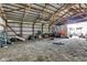 Expanse of barn interior with high ceilings and gravel flooring, suitable for various storage or workshop needs at 10965 W Base Line Rd, Jamestown, IN 46147