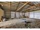 Spacious barn interior with metal framework and gravel flooring, ideal for storage or agricultural use at 10965 W Base Line Rd, Jamestown, IN 46147