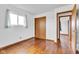 Bedroom with hardwood floors and natural light from a window with decorative curtains at 10965 W Base Line Rd, Jamestown, IN 46147