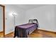 Bedroom with neutral walls, wood floors, stylish lamp and small bed at 10965 W Base Line Rd, Jamestown, IN 46147