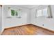 Bright bedroom with hardwood floors, two windows, and decorative curtains at 10965 W Base Line Rd, Jamestown, IN 46147