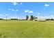 Expansive lot features well-maintained lawn, outbuildings, mature trees, and access to an open field at 10965 W Base Line Rd, Jamestown, IN 46147