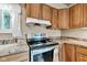 Kitchen corner showcasing the oven, countertops, cabinets, and window at 10965 W Base Line Rd, Jamestown, IN 46147