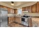 Charming kitchen featuring stainless steel appliances, wood cabinetry and stone countertops at 10965 W Base Line Rd, Jamestown, IN 46147
