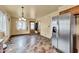 Open living room with neutral walls, stone floors and stainless steel refrigerator at 10965 W Base Line Rd, Jamestown, IN 46147