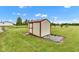 Outdoor storage shed with red trim in a rural setting under a blue sky at 10965 W Base Line Rd, Jamestown, IN 46147