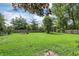 Large green backyard featuring a fire pit and ample space for outdoor activities at 12606 Markay Dr, Fishers, IN 46038