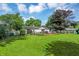 Beautifully landscaped backyard with a deck and ample green space for recreation at 12606 Markay Dr, Fishers, IN 46038