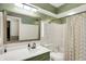 Stylish bathroom featuring modern fixtures, wallpaper, and a shower with decorative curtain at 12606 Markay Dr, Fishers, IN 46038