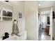Well-lit bathroom with a sleek sink, mirror, toilet and leads to a bright, adjoining room at 12606 Markay Dr, Fishers, IN 46038