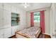Cozy bedroom with built in shelves, a ceiling fan, and a sunlit window at 12606 Markay Dr, Fishers, IN 46038