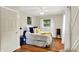 Cozy bedroom featuring a ceiling fan and a bed with white and blue bedding at 12606 Markay Dr, Fishers, IN 46038