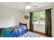 Bright bedroom with a ceiling fan and a window providing natural light at 12606 Markay Dr, Fishers, IN 46038