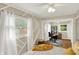 Bright bedroom features stylish decor, ceiling fan, and adjacent office space with ample natural light at 12606 Markay Dr, Fishers, IN 46038