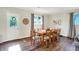 Bright dining room boasts hardwood floors, natural light, and seating for eight at the wooden table at 12606 Markay Dr, Fishers, IN 46038