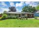 Charming single-story home featuring combination brick and wood facade and lush landscaping at 12606 Markay Dr, Fishers, IN 46038