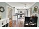 Bright kitchen with white cabinets, stainless steel appliances, a breakfast bar, and stylish tile backsplash at 12606 Markay Dr, Fishers, IN 46038