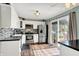 Bright kitchen featuring stainless steel appliances, modern backsplash, and glass door to the backyard at 12606 Markay Dr, Fishers, IN 46038