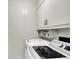 Laundry area features a washer, dryer, and storage cabinets for organization at 12606 Markay Dr, Fishers, IN 46038