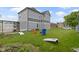 The backyard features lawn space, cornhole game set, colorful chairs, and a custom pergola over the patio at 134 N Elder Ave, Indianapolis, IN 46222