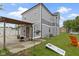 This backyard boasts an area with a patio, cornhole set, orange chair, and flower, perfect for outdoor gatherings at 134 N Elder Ave, Indianapolis, IN 46222