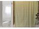 Cozy bathroom with modern fixtures, tile floors, and a shower with a decorative shower curtain at 134 N Elder Ave, Indianapolis, IN 46222