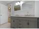 Clean bathroom with a double vanity, modern lighting, and a view to an open door at 134 N Elder Ave, Indianapolis, IN 46222