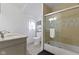 Modern bathroom featuring a shower with glass sliding doors, tiled walls, and a marble-top vanity at 134 N Elder Ave, Indianapolis, IN 46222