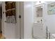 Neat bathroom featuring a white vanity with sink, mirror, and a convenient storage rack at 134 N Elder Ave, Indianapolis, IN 46222