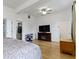 Comfortable bedroom featuring a TV, wardrobe and an open door to an adjoining bathroom at 134 N Elder Ave, Indianapolis, IN 46222