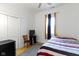 Bright bedroom featuring hardwood floors, ceiling fan, and a window with stylish curtains at 134 N Elder Ave, Indianapolis, IN 46222