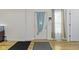 Bright entryway with hardwood floors, featuring a door with light blue curtain and coat rack at 134 N Elder Ave, Indianapolis, IN 46222