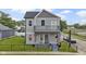 Charming two-story home with a balcony, well-maintained lawn, and a classic gray exterior at 134 N Elder Ave, Indianapolis, IN 46222