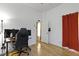 A functional home office space with hardwood floors, an ergonomic chair, and a minimalist desk setup at 134 N Elder Ave, Indianapolis, IN 46222