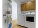 Functional laundry room with modern washer and dryer, and practical storage solutions at 134 N Elder Ave, Indianapolis, IN 46222