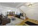 Open-concept living area with hardwood floors, a staircase, and seamless flow to the kitchen at 134 N Elder Ave, Indianapolis, IN 46222