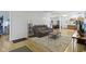 Open concept living room with hardwood floors and comfortable seating area, with access to dining room at 134 N Elder Ave, Indianapolis, IN 46222