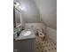 Cozy bathroom features a single sink vanity with white cabinets and unique tile flooring at 1354 Edgemont Ave, Indianapolis, IN 46208