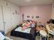 Inviting bedroom with a soft pink wall and bed filled with plush toys at 1439 Silver Pine Ln, Sheridan, IN 46069