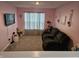 Inviting bedroom with a comfortable couch, TV, and soft pink walls, creating a relaxing and cozy retreat at 1439 Silver Pine Ln, Sheridan, IN 46069