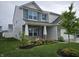 Beautiful home featuring a well-maintained lawn, lovely landscaping, and a welcoming front porch at 1439 Silver Pine Ln, Sheridan, IN 46069