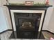 Elegant fireplace with a dark surround and decorative mantel, creating a cozy focal point in the home at 1439 Silver Pine Ln, Sheridan, IN 46069