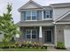 Inviting home showcasing brickwork, blue shutters, and manicured landscaping, enhancing curb appeal at 1439 Silver Pine Ln, Sheridan, IN 46069